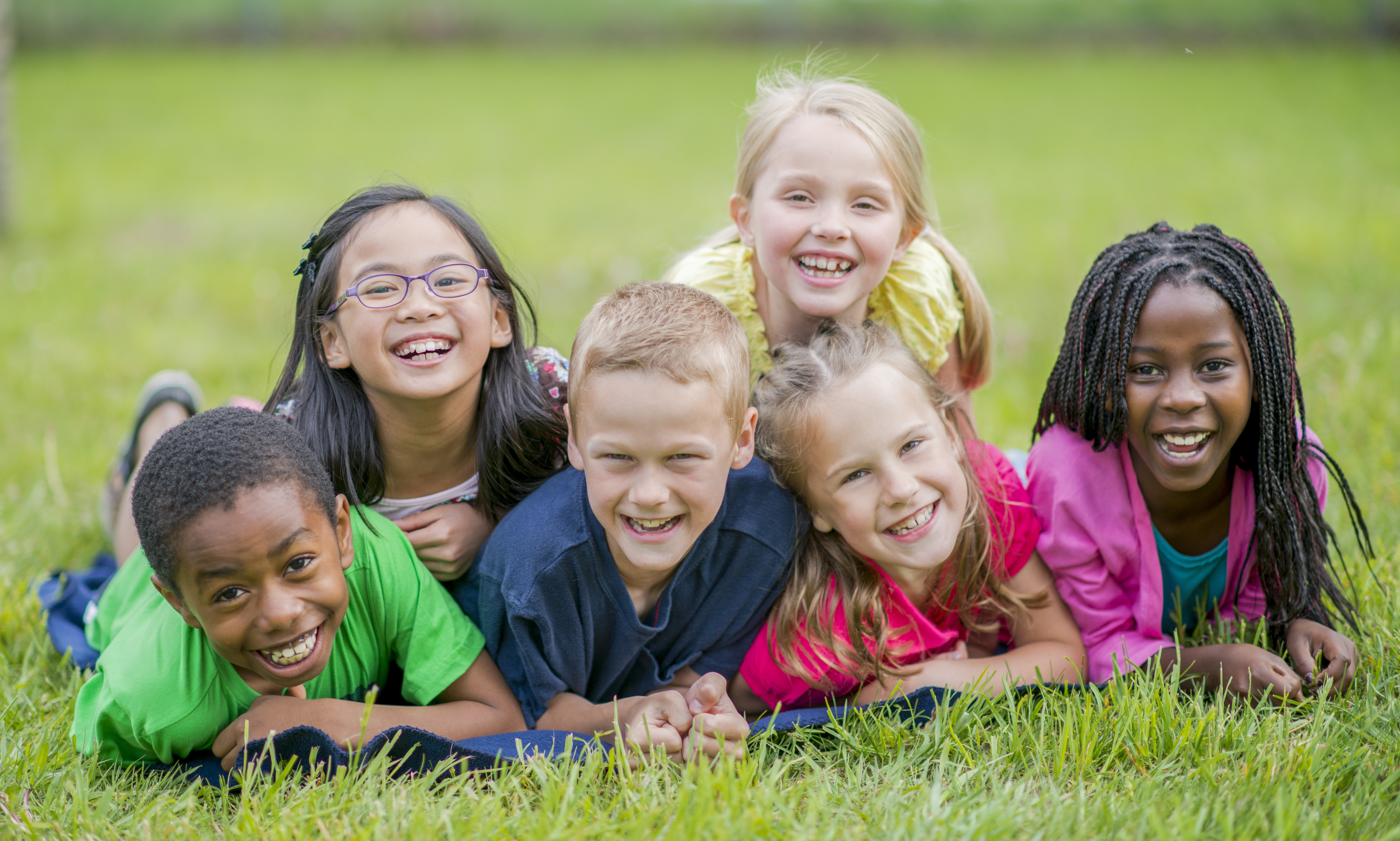 A group of culturally diverse children playing outside