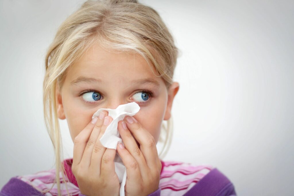 girl blowing her nose